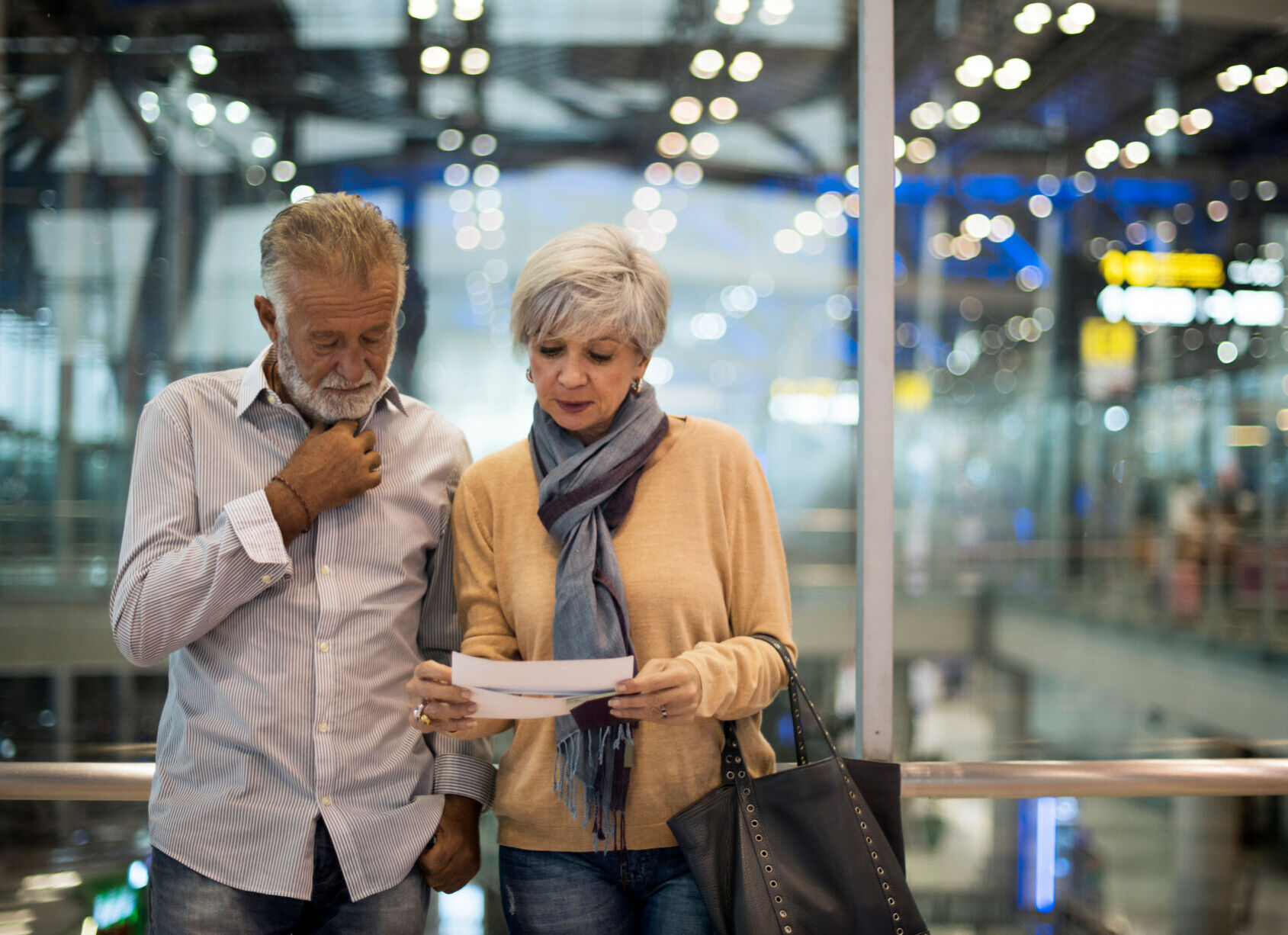 Senior couple traveling airport scene